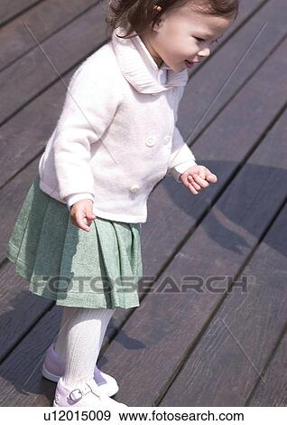 Side profile of a girl standing on a wooden platform View Large Photo Image Stock Photo - Side profile of a girl standing on a wooden platform. Fotosearch