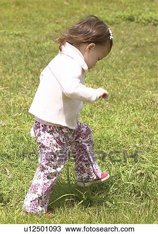 Side profile of a girl walking in the grass View Large Photo Image Stock Image - Side profile of a girl walking in the grass. Fotosearch