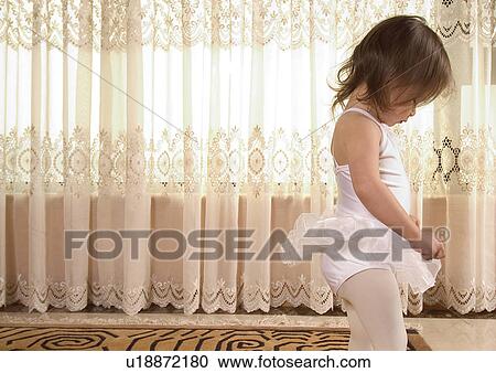 Stock Image - Side profile of a girl wearing a tutu. Fotosearch