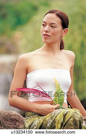 Stock Image - ponytail, sitting, calm, blurred, serene, silence, leisure activity. Fotosearch