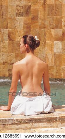 Stock Image - relaxation, looking sideways, day, semi dressed, spa treatment, silence, leisure activity. Fotosearch