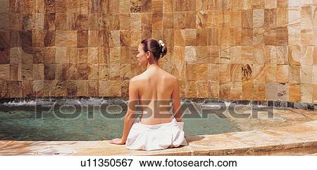 Stock Photo - relaxation, semi dressed, lifestyle, waist up, rear view. Fotosearch