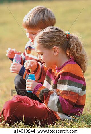 Picture - blonde hair, bottle, brother, carefree. Fotosearch