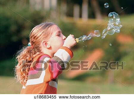 Stock Photography - blonde hair, bubble wand, bubbles, carefree. Fotosearch