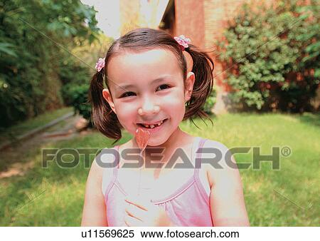 Stock Photography - blonde hair, candy, carefree, casual. Fotosearch