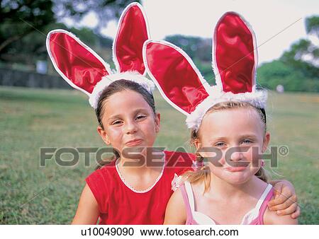 Stock Image - blonde hair, casual, carefree, arm around. Fotosearch