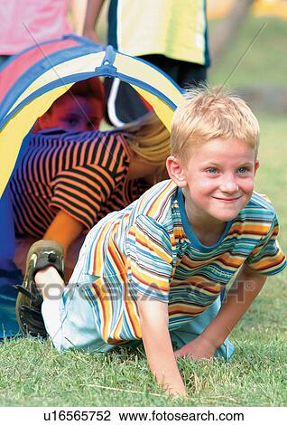 Stock Image - child, short sleeved, casual, lifestyle, park, tent. Fotosearch
