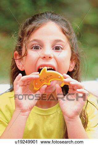 Stock Image - fish shape, portrait, outdoor, blonde hair, day, cheerful. Fotosearch