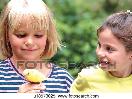 Stock Photography - girl, bird, blonde hair, playing, relative, carefree. Fotosearch