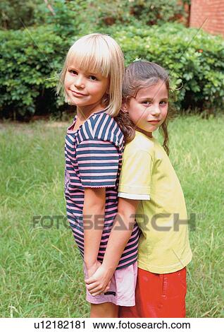 Stock Image - grinning, girl, casual, lifestyle, leaning, looking at camera. Fotosearch