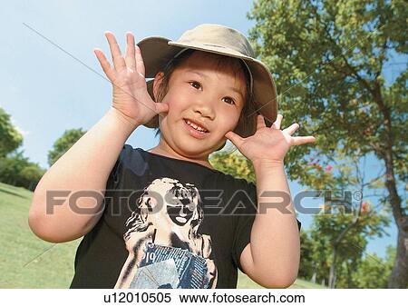 grinning, standing, kid, male, headdress, grass View Large Photo Image Stock Photography - grinning, standing, kid, male, headdress, grass. Fotosearch
