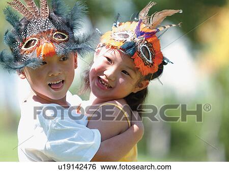 Stock Photograph - happiness, grinning, holding, casual, child. Fotosearch