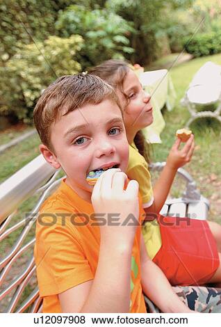 Stock Photo - playing, girl, grinning, bench, childhood. Fotosearch