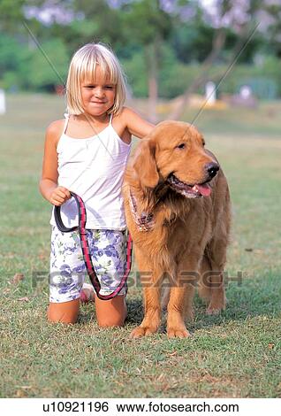 Stock Photograph - young girl, innocence, childhood, grass, carefree, sitting, youth. Fotosearch