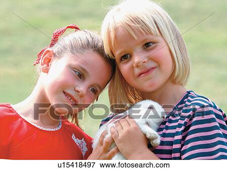Stock Photo - youth, friend, blonde hair, young girl, sisters, head and shoulders, outdoor. Fotosearch