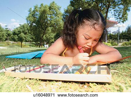 Stock Image - black hair, grass, head and shoulders, straight hair, children's wear. Fotosearch