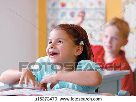 Stock Image - blonde hair, book, boy, casual. Fotosearch