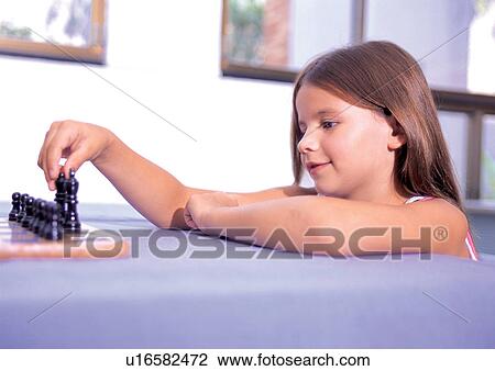 Stock Image - blonde hair, close-up, childhood, short sleeved, head and shoulders, sitting. Fotosearch