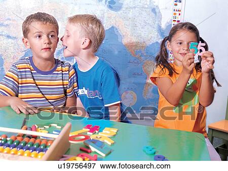 Stock Photo - blonde hair, three people, male, black hair, female, standing, talking. Fotosearch
