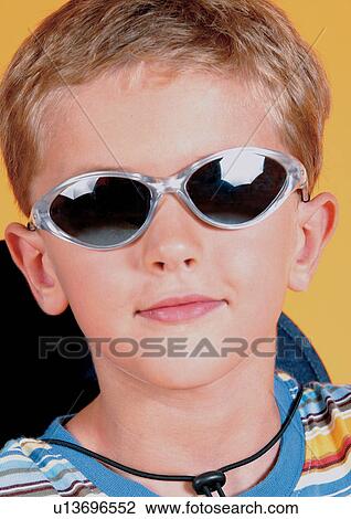 Stock Image - boy, indoor, straight hair, happy, childhood, eye glasses. Fotosearch