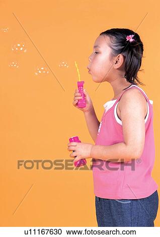 Stock Image - bubble wand, bubbles, standing, holding, human face. Fotosearch