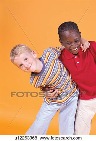 Stock Photo - grinning, human face, casual, children's wear, t-shirt. Fotosearch