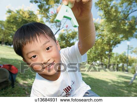 Stock Image - holding, standing, human hands, casual, children's wear. Fotosearch