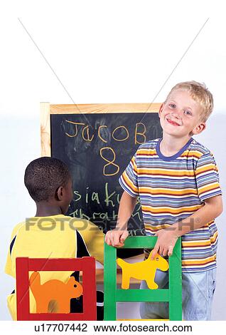 Stock Image - rear view, portrait, boy, indoor, quarter length. Fotosearch