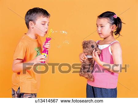 Stock Photo - sister, cheerful, childhood, carefree, children's wear, two people. Fotosearch