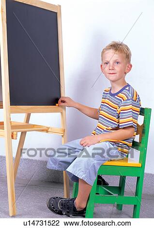Stock Image - sitting, grinning, leisure, casual, one person, chair. Fotosearch