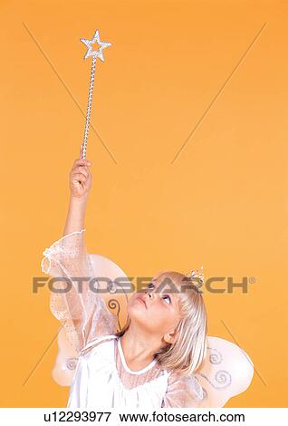 Stock Photo - youth, magic wand, young, standing, female, childhood. Fotosearch