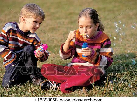 blowing, with families, park, bond, young boy View Large Photo Image Stock Photo - blowing, with families, park, bond, young boy. Fotosearch