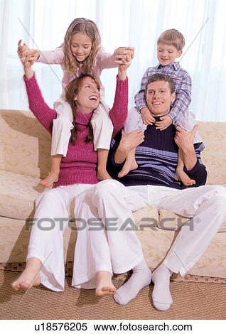 Stock Photography - father, 4-5 years, young girl, sofa, with families, toothy smile. Fotosearch