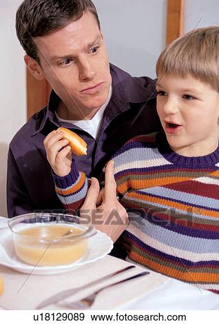 food and drink, family with one child, house, looking away, eating, sitting on lap View Large Photo Image Stock Photo - food and drink, family with one child, house, looking away, eating, sitting on lap. Fotosearch