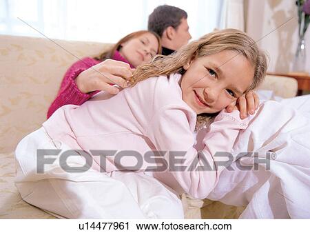 Stock Image - indoor, father, 7-8 years, mid adult man, three people. Fotosearch