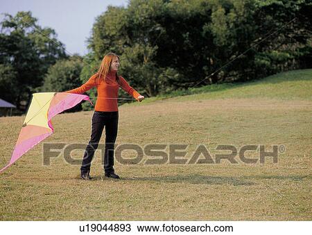 Stock Image - kite, looking sideways, shadow, one person. Fotosearch