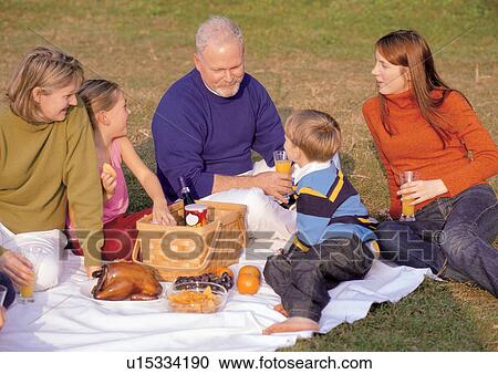 Stock Image - orange juice, mother, mid adult woman, happiness. Fotosearch