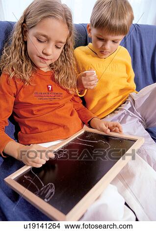 quarter length, indoor, black board, children, sister, family View Large Photo Image Picture - quarter length, indoor, black board, children, sister, family. Fotosearch