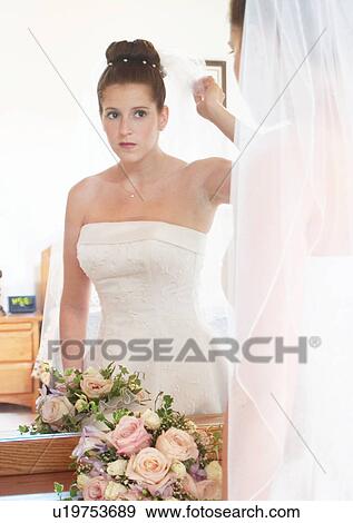 Stock Photo - Holding, Standing, Mirror. Fotosearch