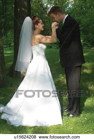 Stock Photo - Holding, Standing, Smiling. Fotosearch