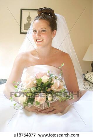 Stock Photo - Holding, Standing, Smiling. Fotosearch