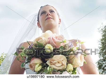 Stock Image - Holding, Standing, Wedding Dress, Veil. Fotosearch