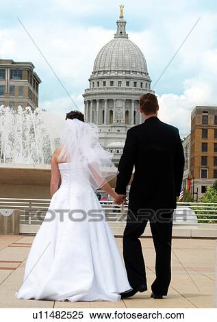 Stock Photography - Holding, Walking, Wedding Dress. Fotosearch