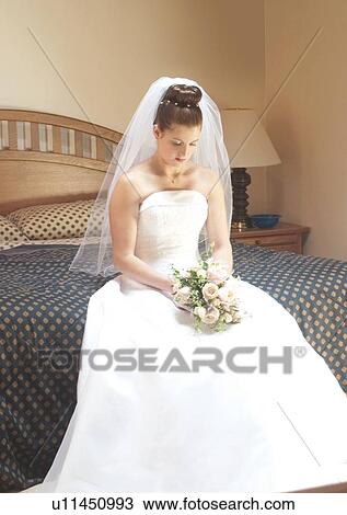 Stock Image - Sitting, Holding, Wedding Dress. Fotosearch