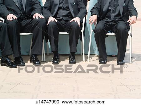 Stock Image - Sitting, People In A Row, Hands On Knees, Full Suit. Fotosearch