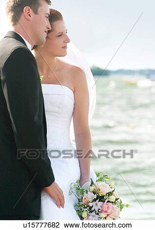 Stock Image - Standing, Holding, Full Suit. Fotosearch