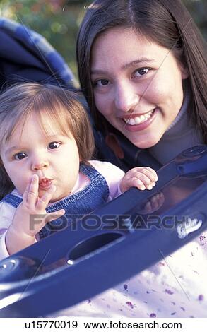 Stock Photo - Woman Posing with Baby Girl. Fotosearch