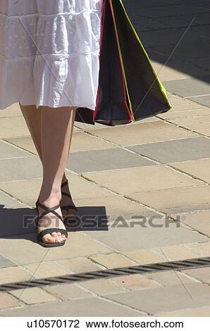 Stock Image - Woman, Shopping, Casual wear, Skirt, Detail, Leg, Legs. Fotosearch