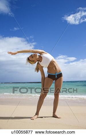 Caucasian young adult woman stretching on beach. View Large Photo Image Stock Photo - Caucasian young adult woman stretching on beach.. Fotosearch