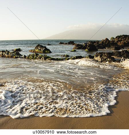 Landscape of waves lapping on rocky beach. View Large Photo Image Stock Image - Landscape of waves lapping on rocky beach.. Fotosearch